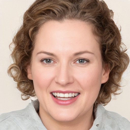 Joyful white young-adult female with medium  brown hair and green eyes