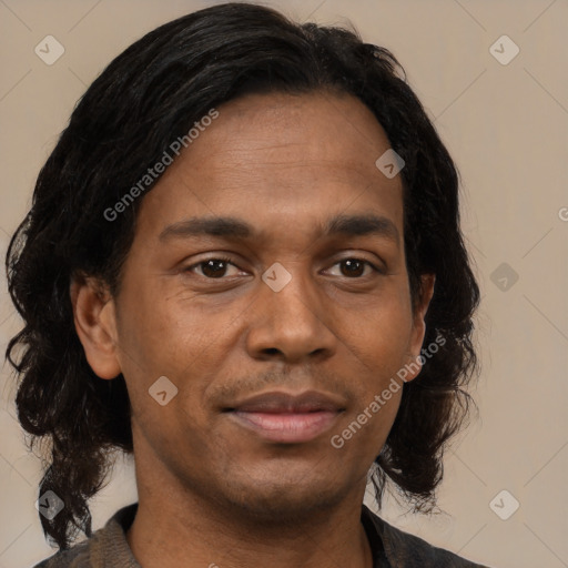 Joyful black young-adult male with short  brown hair and brown eyes