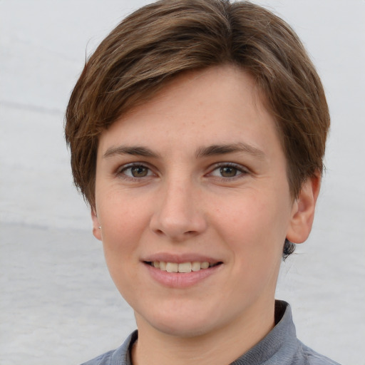 Joyful white young-adult female with short  brown hair and grey eyes