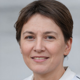 Joyful white adult female with short  brown hair and brown eyes