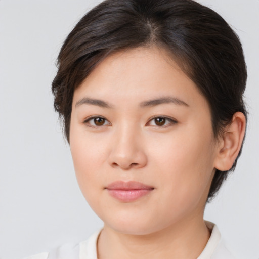 Joyful asian young-adult female with medium  brown hair and brown eyes