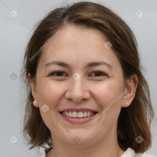 Joyful white adult female with medium  brown hair and brown eyes