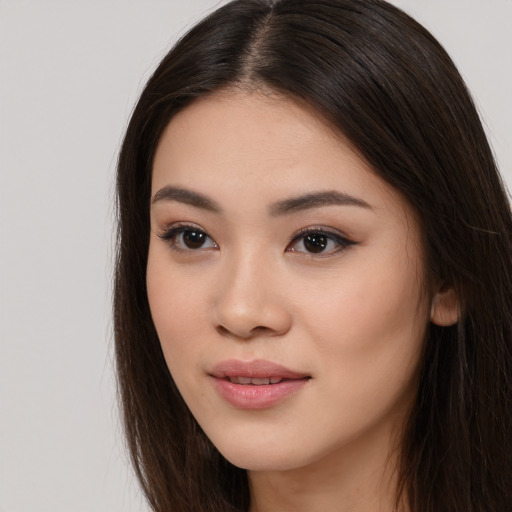 Joyful asian young-adult female with long  brown hair and brown eyes