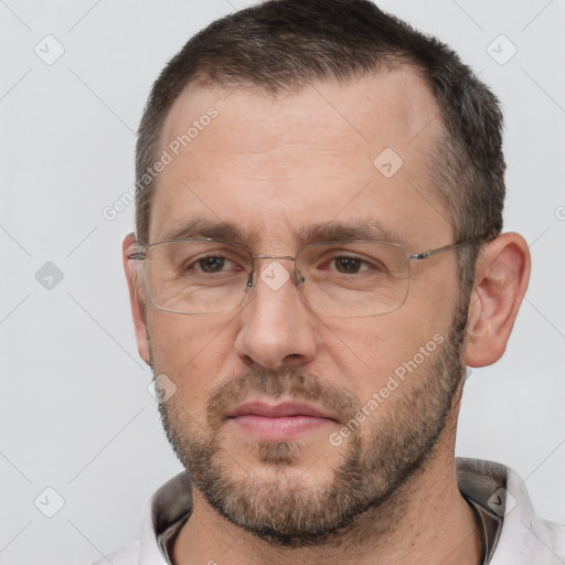 Joyful white adult male with short  brown hair and brown eyes