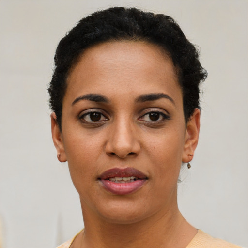 Joyful latino young-adult female with short  brown hair and brown eyes