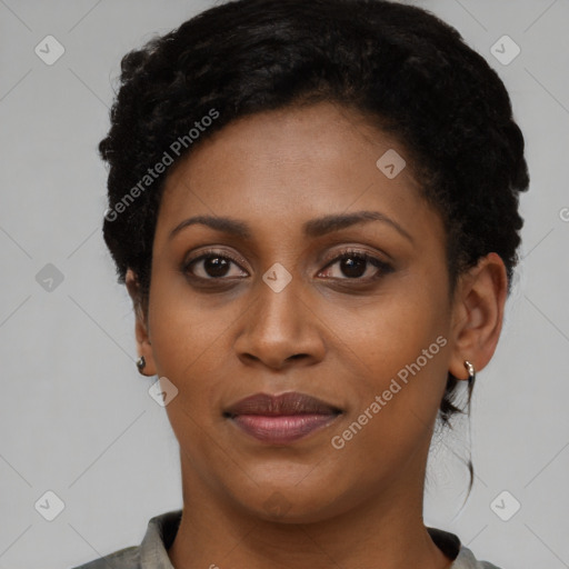 Joyful black young-adult female with short  black hair and brown eyes