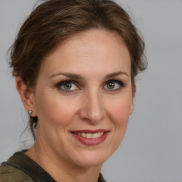 Joyful white adult female with medium  brown hair and grey eyes