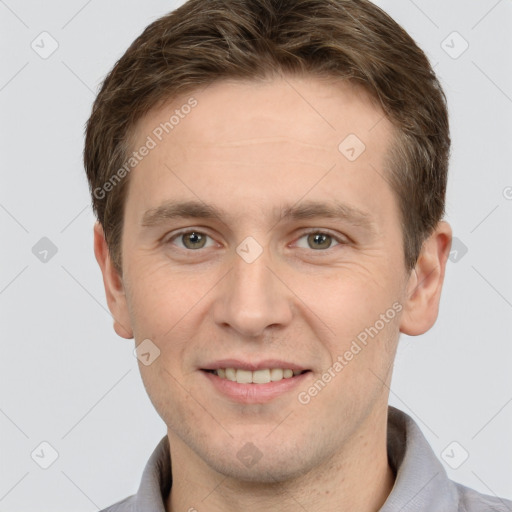 Joyful white young-adult male with short  brown hair and grey eyes