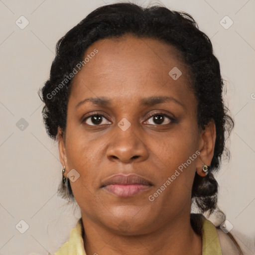 Joyful black adult female with short  brown hair and brown eyes