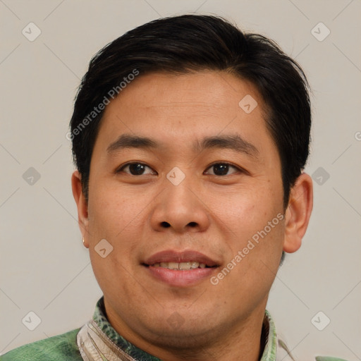 Joyful asian adult male with short  brown hair and brown eyes
