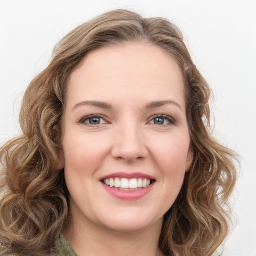 Joyful white young-adult female with long  brown hair and green eyes