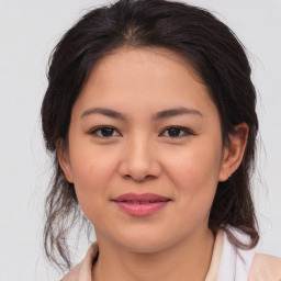 Joyful asian young-adult female with medium  brown hair and brown eyes