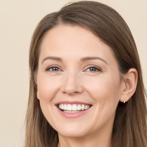 Joyful white young-adult female with long  brown hair and brown eyes