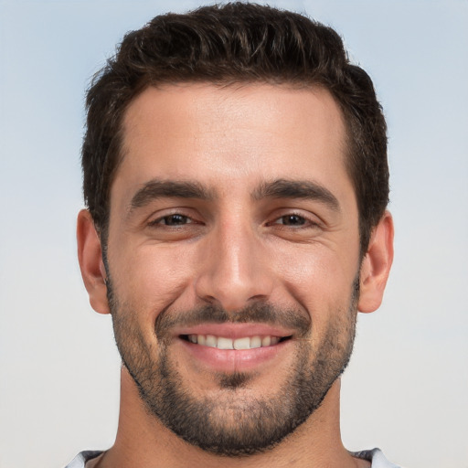 Joyful white young-adult male with short  black hair and brown eyes