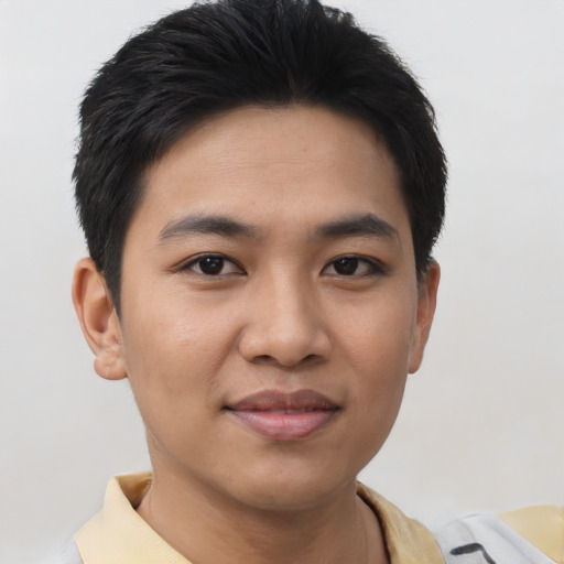 Joyful asian young-adult male with short  black hair and brown eyes