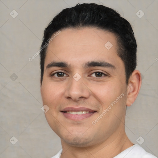 Joyful white young-adult male with short  black hair and brown eyes