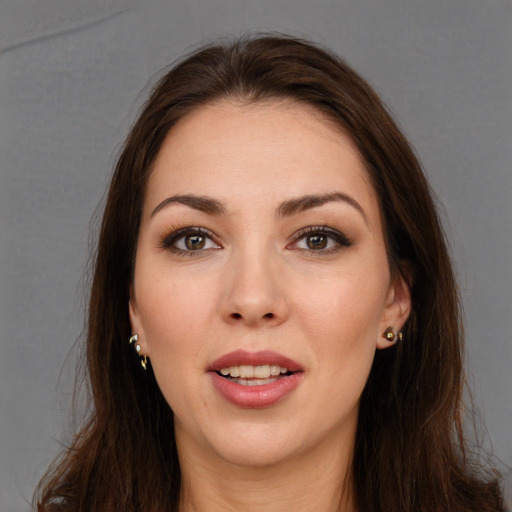 Joyful white young-adult female with long  brown hair and brown eyes