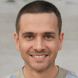 Joyful white young-adult male with short  brown hair and brown eyes