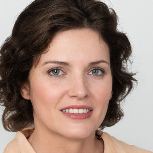 Joyful white young-adult female with medium  brown hair and green eyes