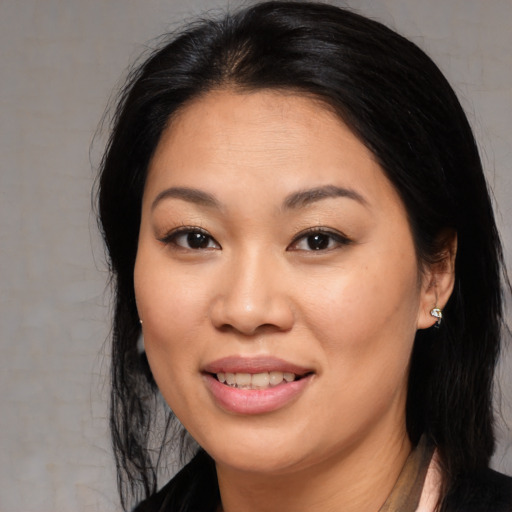 Joyful asian young-adult female with medium  brown hair and brown eyes