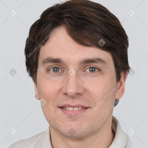 Joyful white adult male with short  brown hair and grey eyes