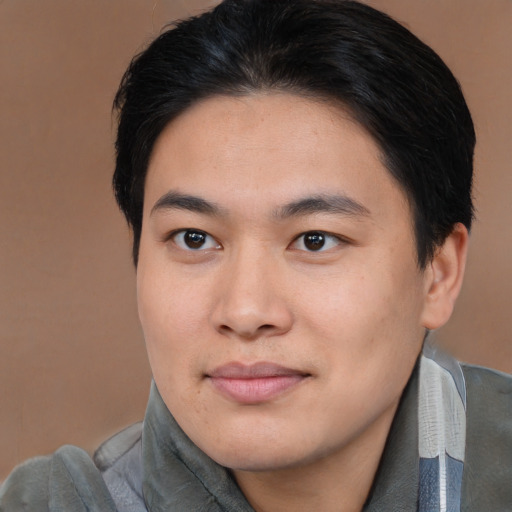 Joyful asian young-adult male with short  brown hair and brown eyes