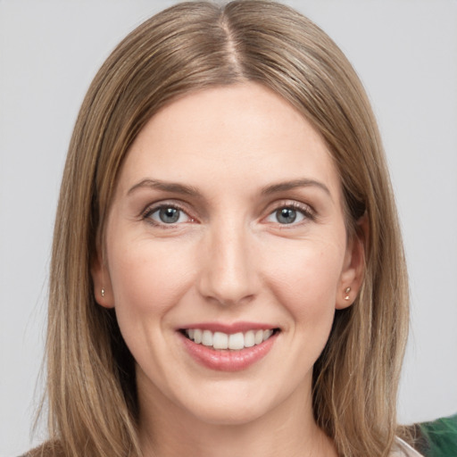 Joyful white young-adult female with long  brown hair and grey eyes