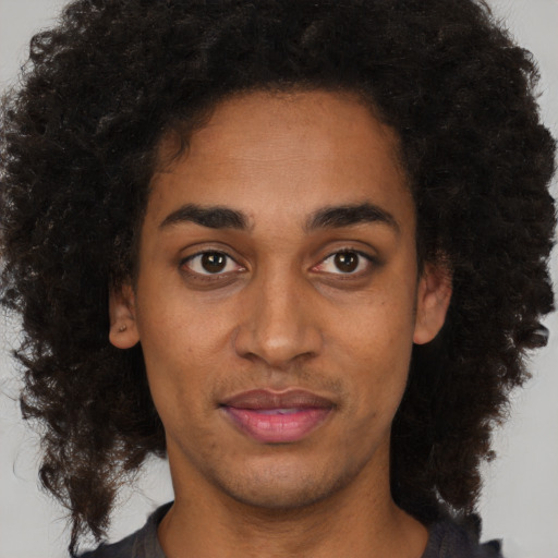 Joyful black young-adult male with short  brown hair and brown eyes