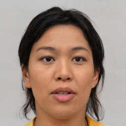 Joyful asian young-adult female with medium  brown hair and brown eyes