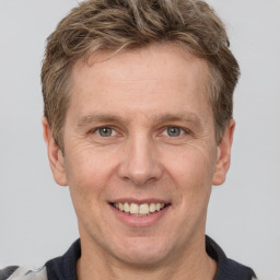 Joyful white adult male with short  brown hair and grey eyes