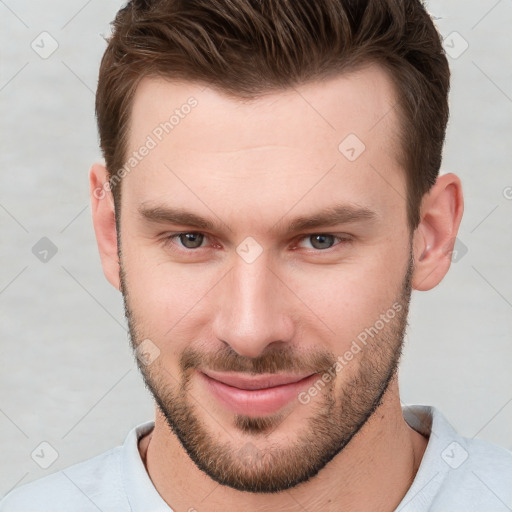 Joyful white young-adult male with short  brown hair and brown eyes