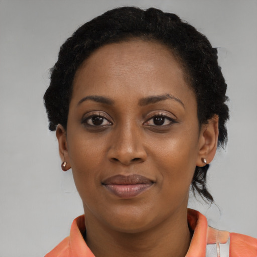 Joyful black young-adult female with medium  black hair and brown eyes