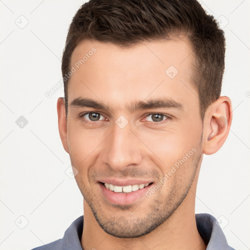 Joyful white young-adult male with short  brown hair and brown eyes