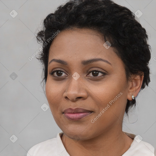 Joyful black young-adult female with short  black hair and brown eyes