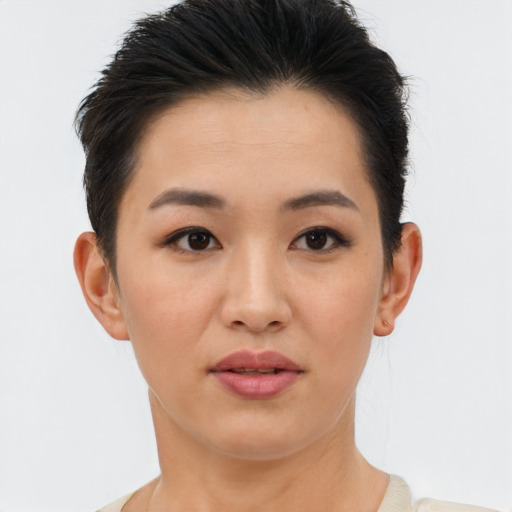 Joyful asian young-adult female with short  brown hair and brown eyes