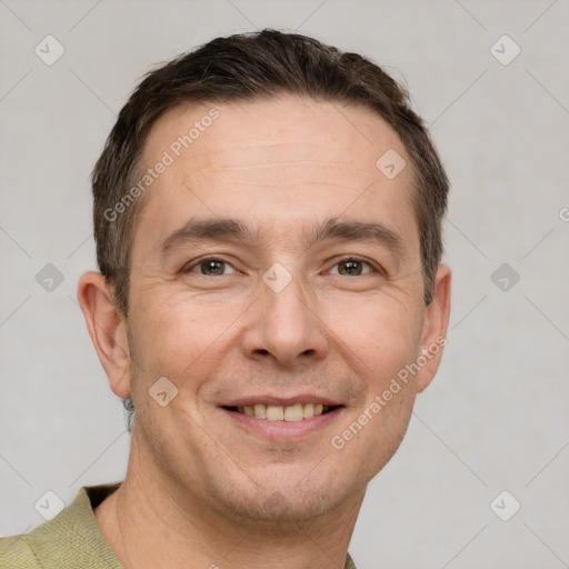 Joyful white adult male with short  brown hair and grey eyes