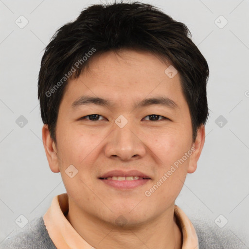 Joyful asian young-adult male with short  brown hair and brown eyes