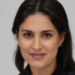 Joyful white adult female with long  brown hair and brown eyes