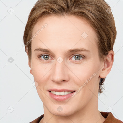 Joyful white young-adult female with short  brown hair and grey eyes