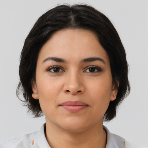 Joyful latino young-adult female with medium  brown hair and brown eyes