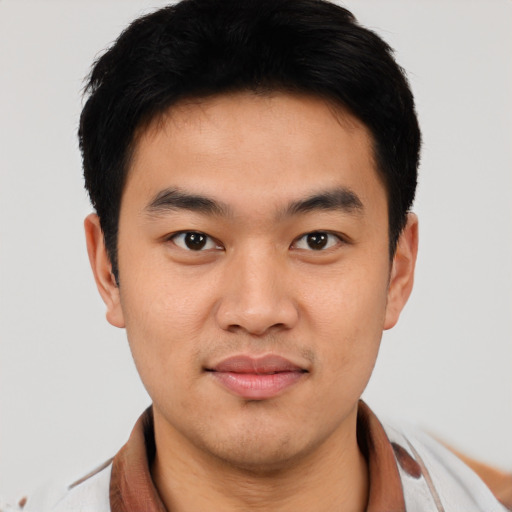 Joyful asian young-adult male with short  black hair and brown eyes