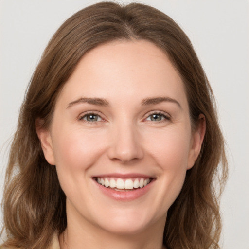 Joyful white young-adult female with medium  brown hair and green eyes