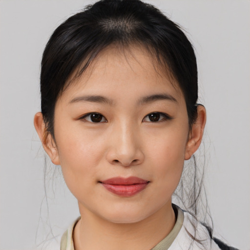 Joyful asian young-adult female with medium  brown hair and brown eyes