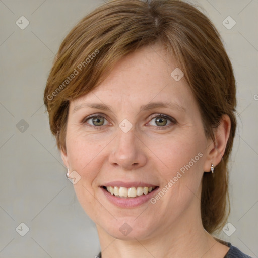 Joyful white adult female with medium  brown hair and grey eyes