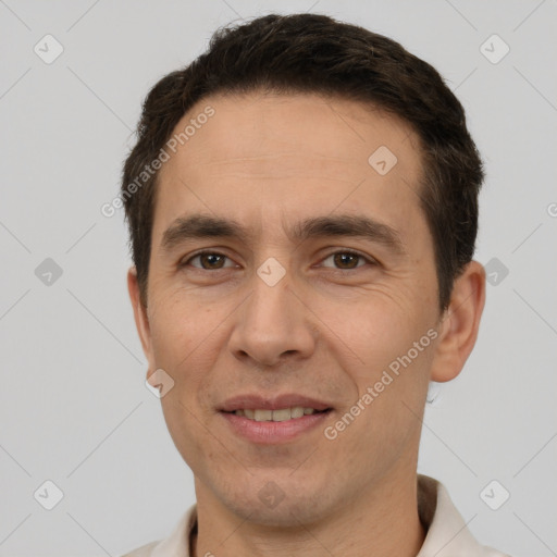 Joyful white adult male with short  brown hair and brown eyes