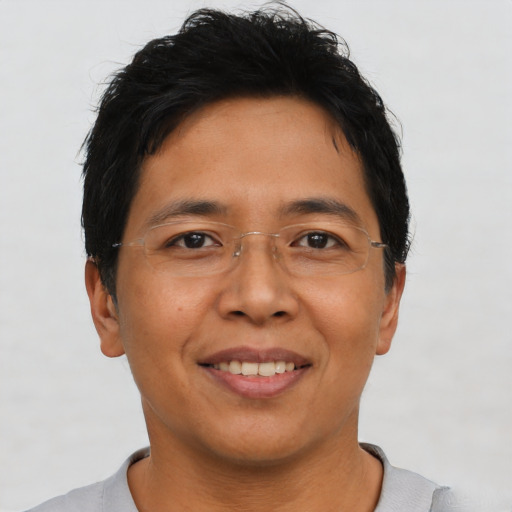 Joyful asian adult male with short  brown hair and brown eyes