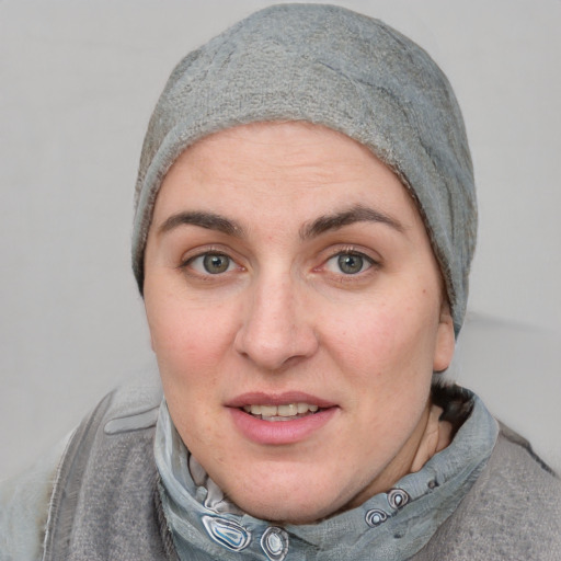 Joyful white adult female with short  brown hair and blue eyes