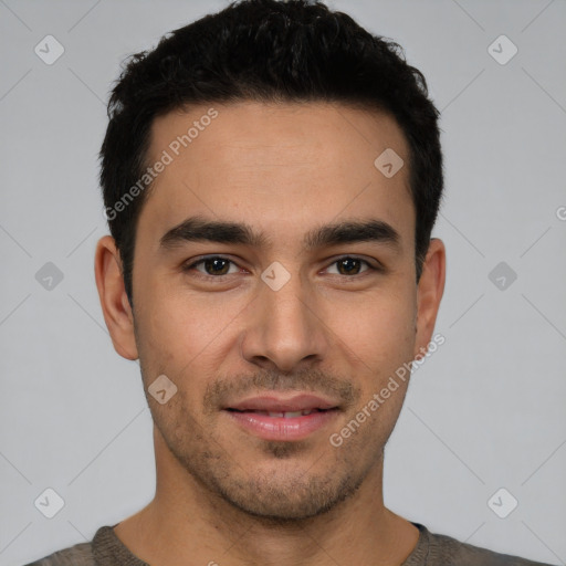 Joyful white young-adult male with short  black hair and brown eyes