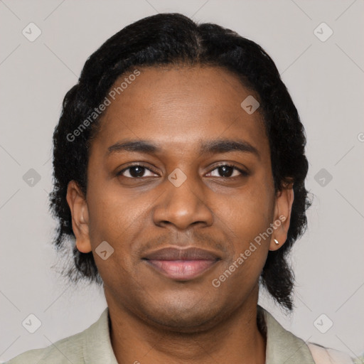 Joyful black young-adult male with short  black hair and brown eyes