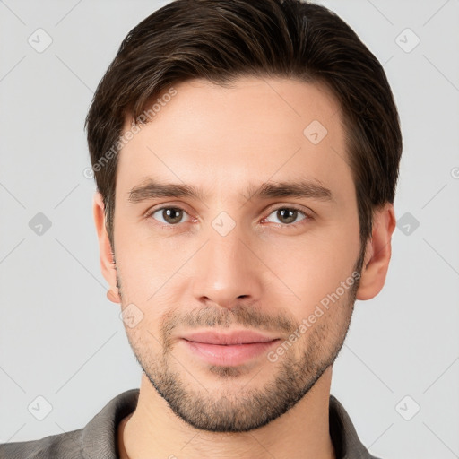 Joyful white young-adult male with short  brown hair and brown eyes